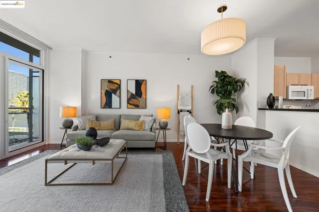 a living room with furniture potted plant and white walls