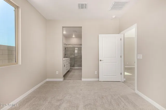 an empty room with an entrance to other room