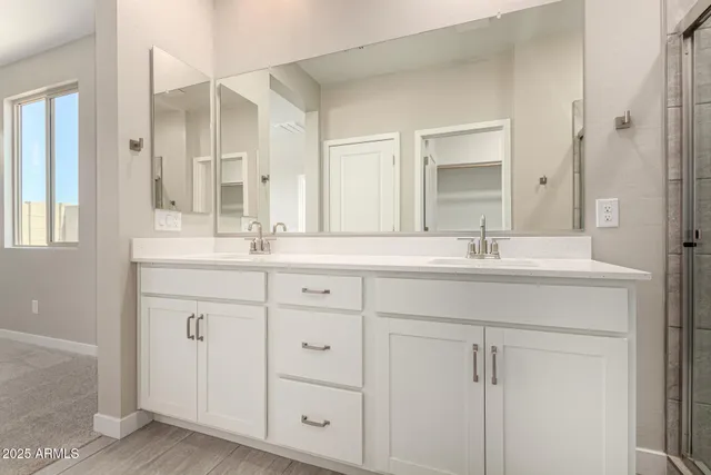 a bathroom with double sink and a mirror