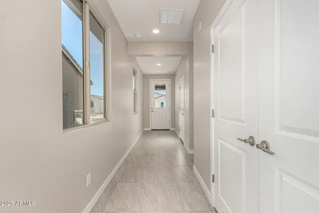 a view of a hallway with wooden floor and closet