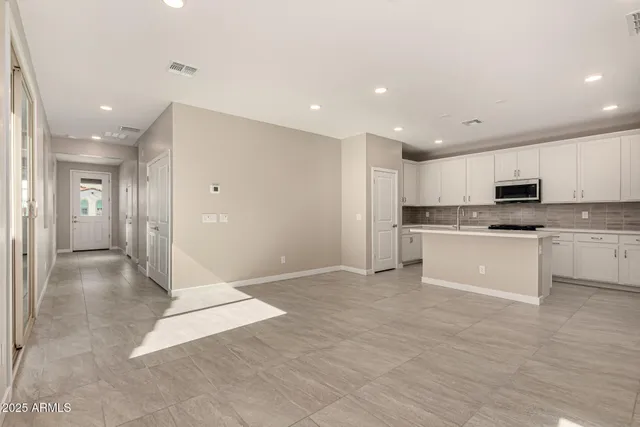 a view of kitchen with granite countertop cabinets and white appliances