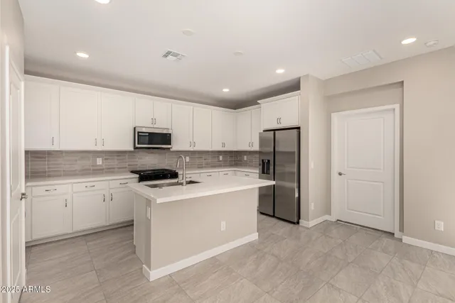 a kitchen with a stove a sink and a refrigerator