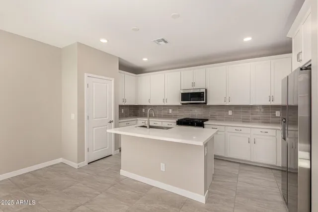 a kitchen with a sink a stove top oven and white kitchen