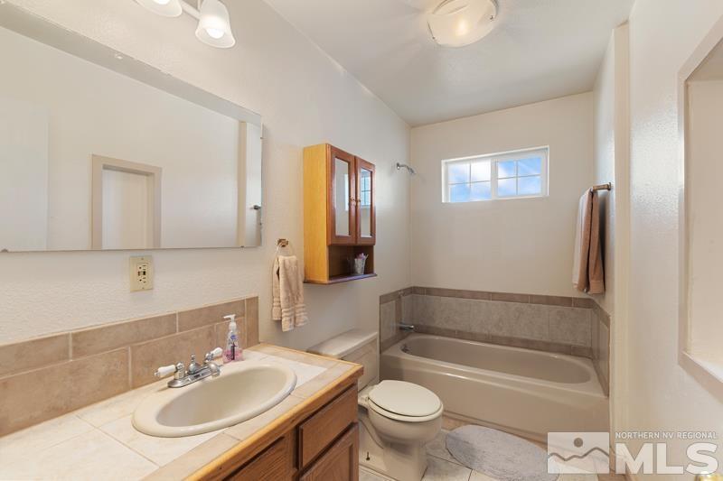2920 Bullfrog Road Reno, NV 89521 - Photo 17 of 40 a bathroom with a sink a toilet and shower