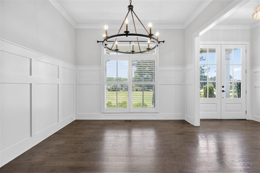 3528 North Bogan Road Buford, GA 30519 - Photo 6 of 79 an empty room with wooden floor fan and windows