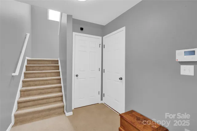 a view of an empty room with stairs