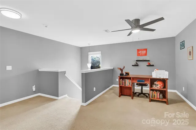 a view of a livingroom with furniture and a ceiling fan