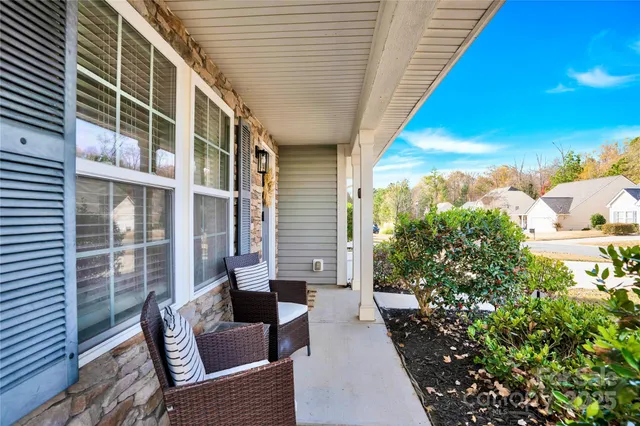 a balcony with furniture and a potted plant
