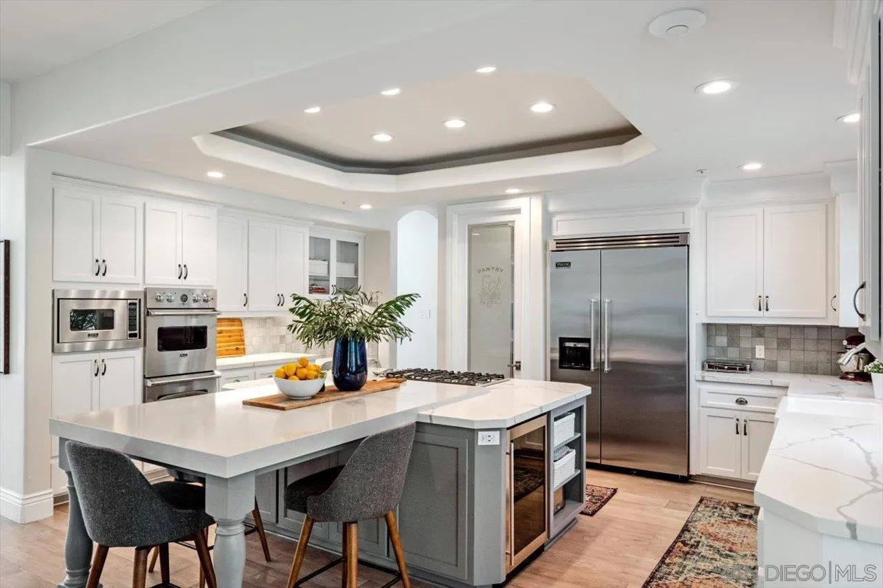 16270 Windpiper Road Poway, CA 92064 - Photo 11 of 65 a kitchen with a sink stainless steel appliances and white cabinets
