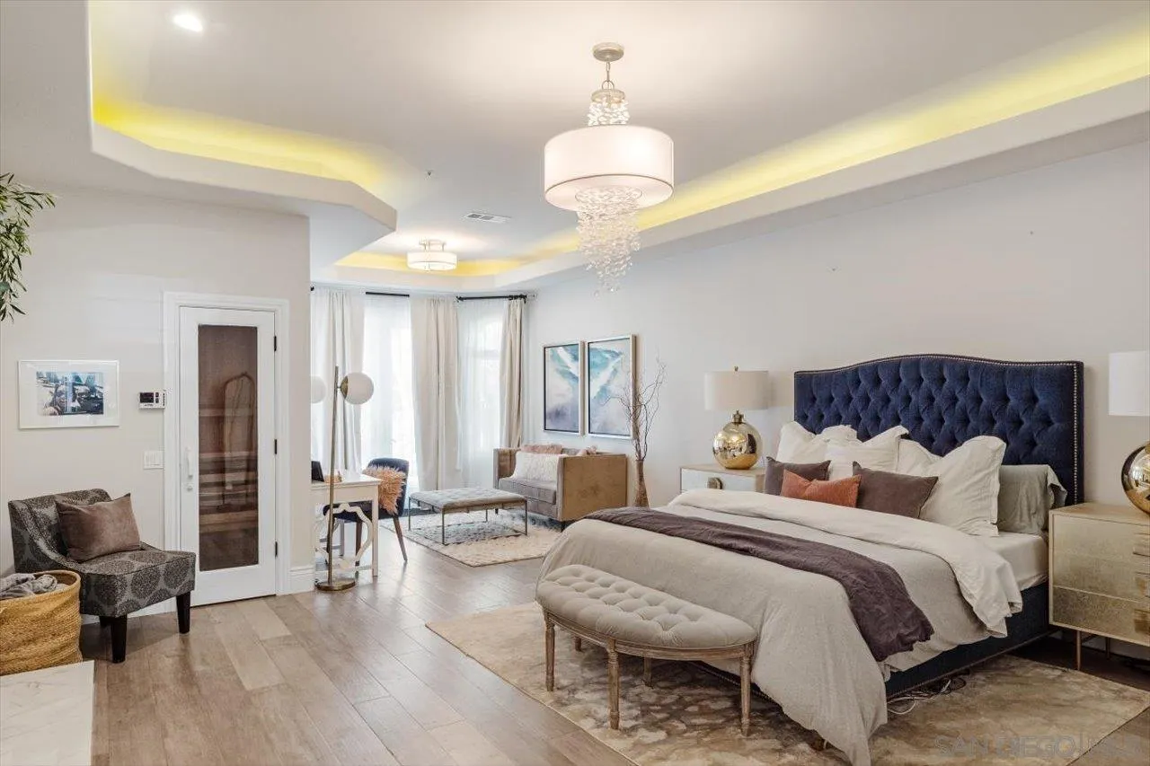 16270 Windpiper Road Poway, CA 92064 - Photo 19 of 65 a bedroom with bed and a chandelier