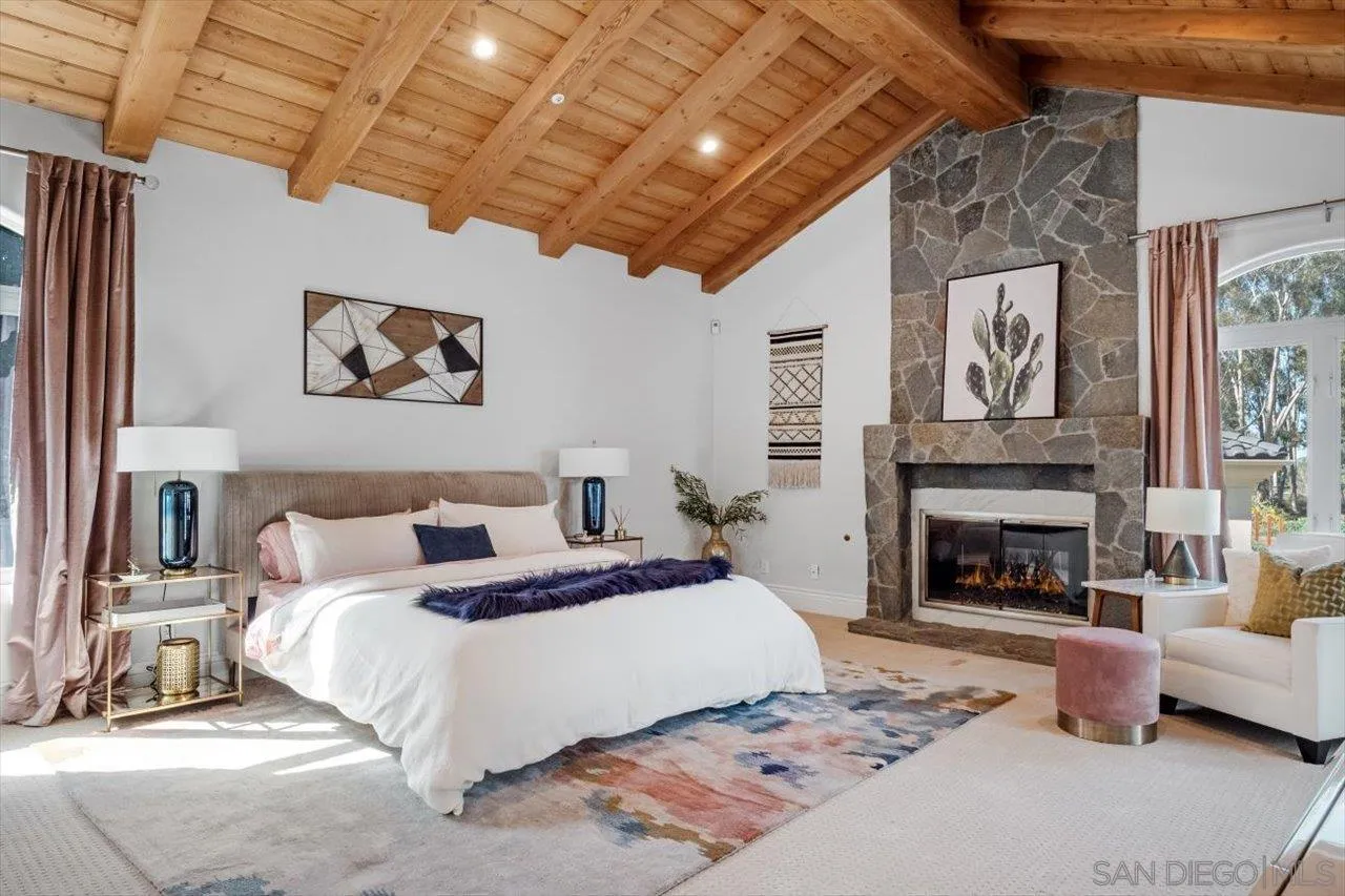 16270 Windpiper Road Poway, CA 92064 - Photo 25 of 65 a spacious bedroom with a bed and a fireplace