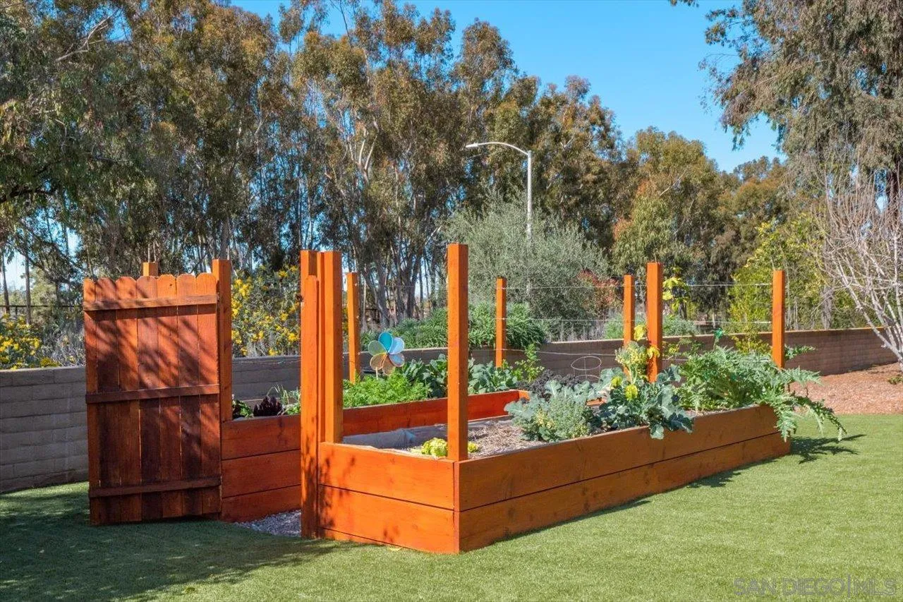 16270 Windpiper Road Poway, CA 92064 - Photo 31 of 65 a view of backyard with wooden fence and a tree
