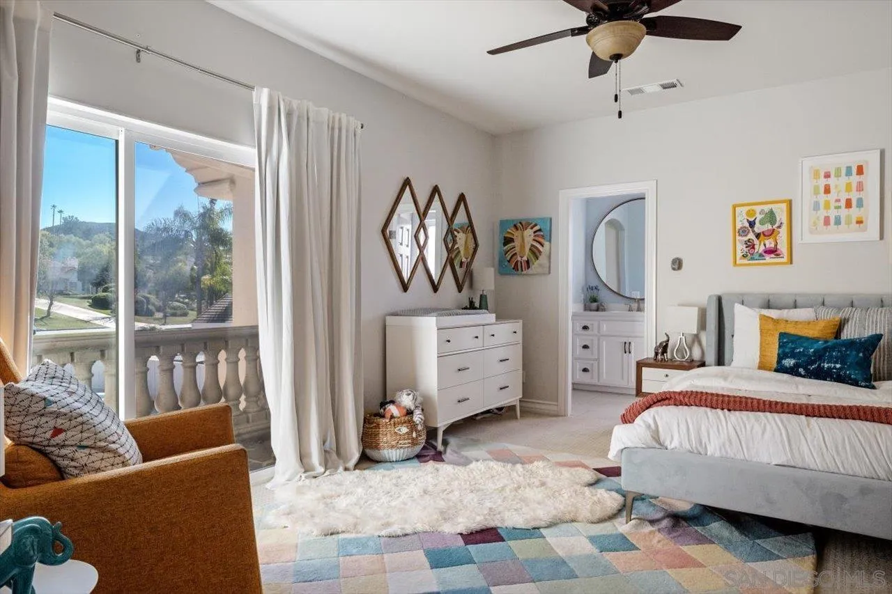16270 Windpiper Road Poway, CA 92064 - Photo 49 of 65 a bedroom with a bed couch and a window