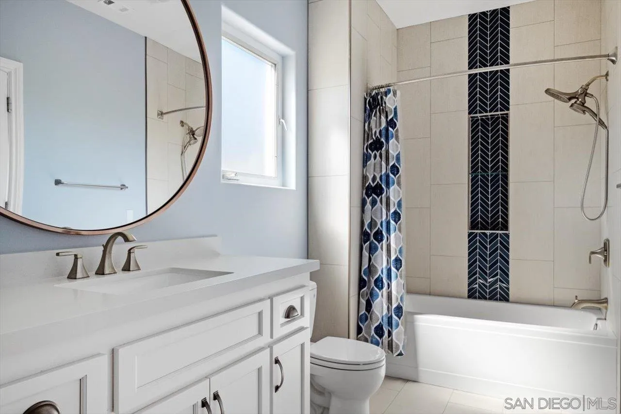 16270 Windpiper Road Poway, CA 92064 - Photo 50 of 65 a bathroom with a sink a toilet and a mirror