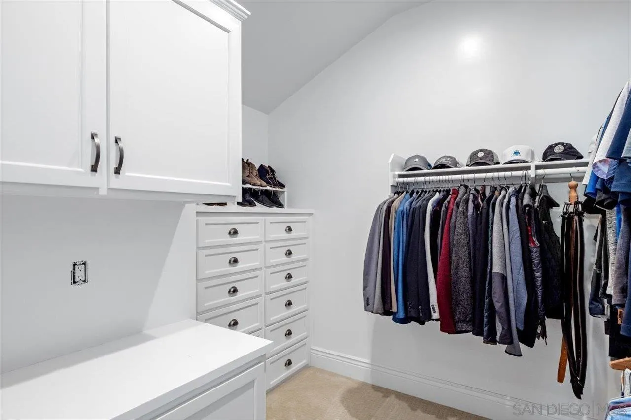 16270 Windpiper Road Poway, CA 92064 - Photo 57 of 65 a view of walk in closet with clothes and shoes