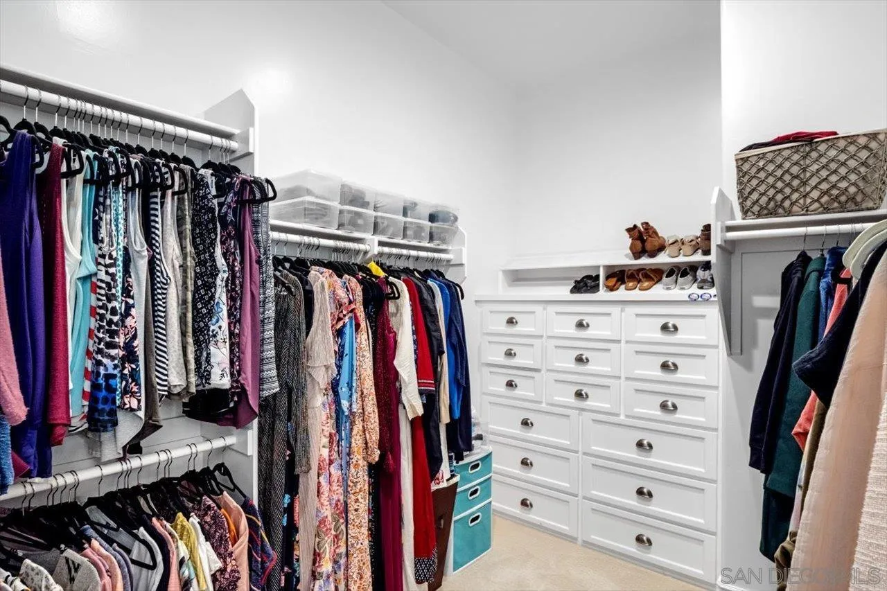 16270 Windpiper Road Poway, CA 92064 - Photo 58 of 65 a view of walk in closet with clothes and shoes