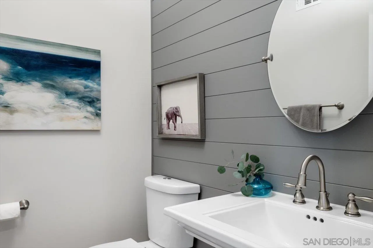 16270 Windpiper Road Poway, CA 92064 - Photo 62 of 65 a bathroom with a toilet sink and mirror