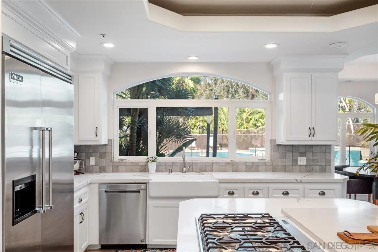 16270 Windpiper Road Poway, CA 92064 - Photo 8 of 65 a kitchen with stainless steel appliances granite countertop a sink stove and refrigerator