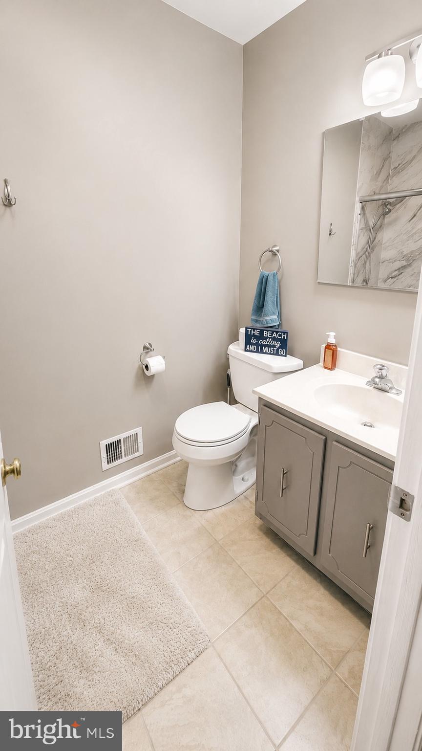 15370 Inlet Place Dumfries, VA 22025 - Photo 16 of 30 a bathroom with a sink toilet and a mirror