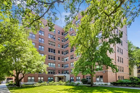 a large building with a trees in front of it