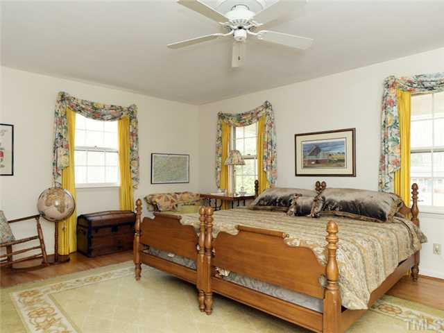 4413 Pitt Street Raleigh, NC 27609 - Photo 18 of 25 a bedroom with a bed and dresser