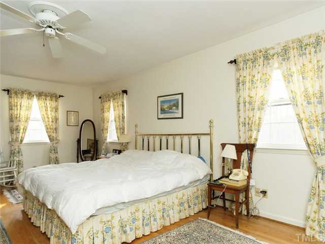 4413 Pitt Street Raleigh, NC 27609 - Photo 21 of 25 a bedroom with a bed and a table in it