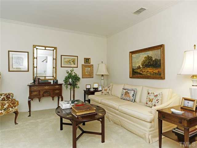 4413 Pitt Street Raleigh, NC 27609 - Photo 7 of 25 a living room with furniture and paintings on the wall