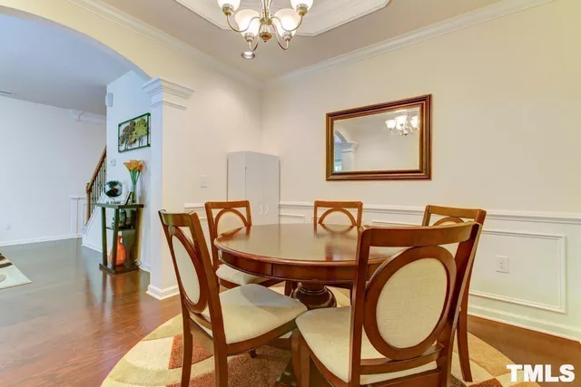a dining room with furniture a rug and wooden floor
