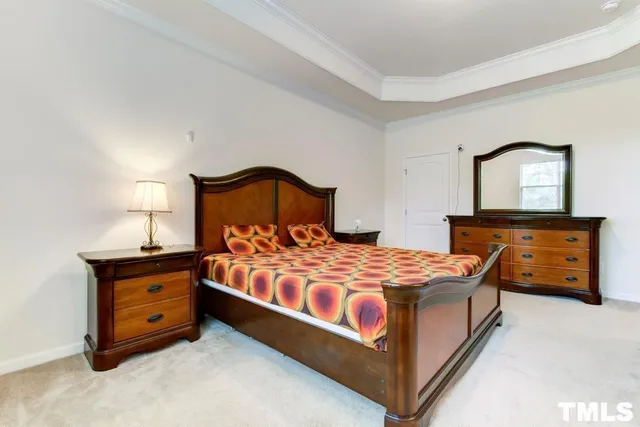 a bedroom with a bed and a dresser in it