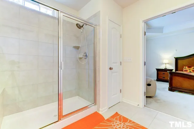 a spacious bathroom with a shower and a sink