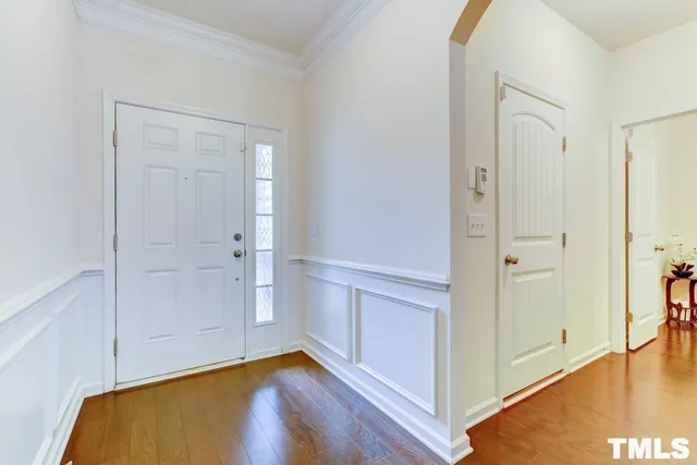 a view of an empty room and wooden floor