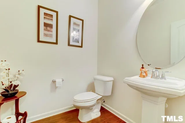 a bathroom with a sink mirror and toilet