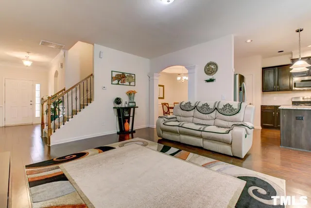 a living room with furniture windows and a flat screen tv