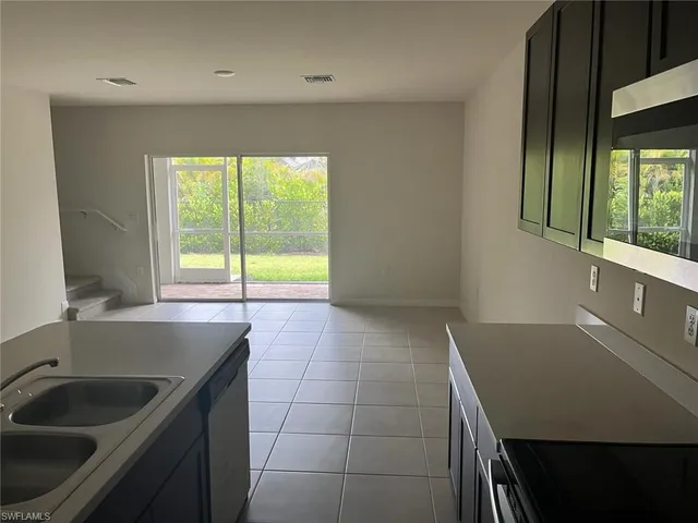 a kitchen with a sink a stove and a window