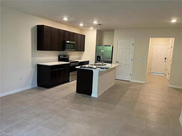 a kitchen with a sink a counter top space and cabinets