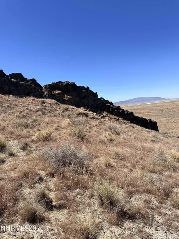 a view of mountain with sunset in background