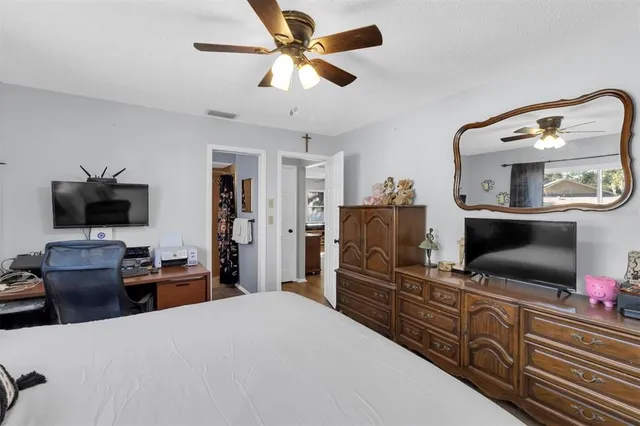 a bedroom with furniture and a flat screen tv