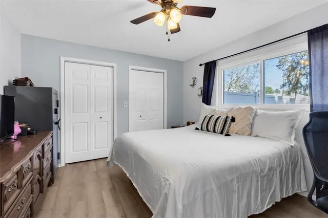 a bedroom with a bed and a chandelier