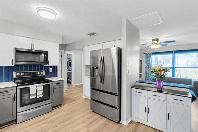 a kitchen with stainless steel appliances a refrigerator stove and microwave