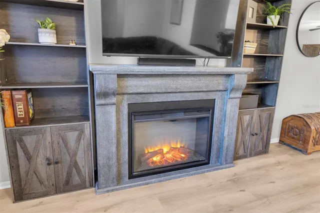 a living room with a fireplace and a fireplace