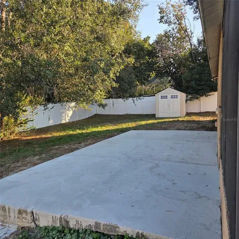 a view of a house with a yard and sitting area