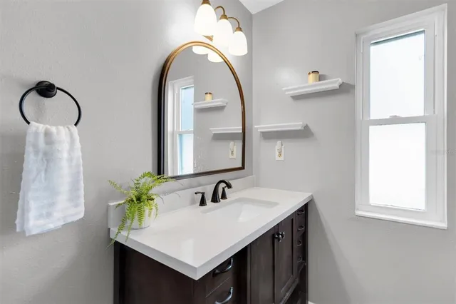 a bathroom with a sink and a mirror