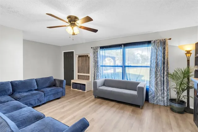 a living room with furniture and a large window