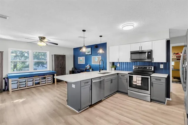 a kitchen with stainless steel appliances granite countertop a stove and a sink