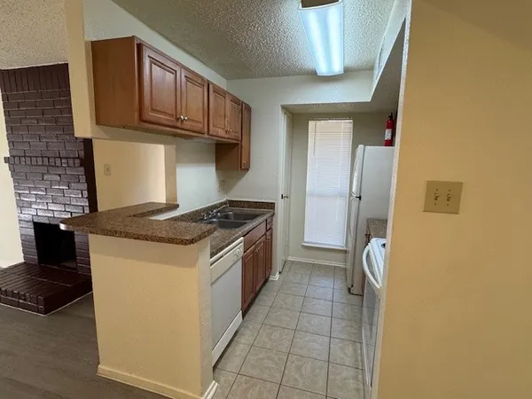 a kitchen with a stove and a refrigerator