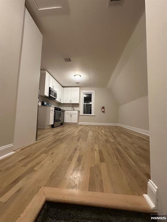 65 Lincoln Place, Unit 2 Garfield, NJ 07026 - Photo 3 of 13 a view of kitchen island with wooden floor