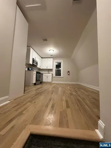 a view of kitchen island with wooden floor