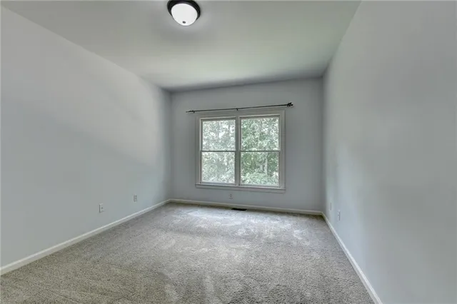 an empty room with a empty space and a window