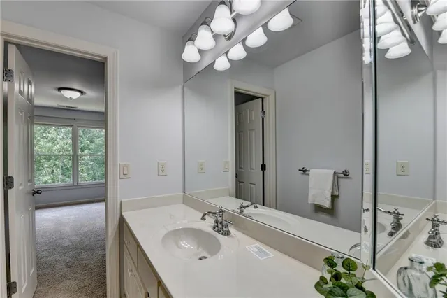 a bathroom with a sink vanity granite and a mirror