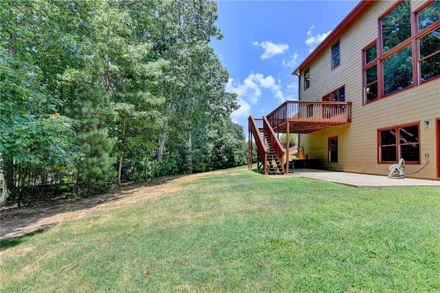 a view of a house with a yard and sitting area